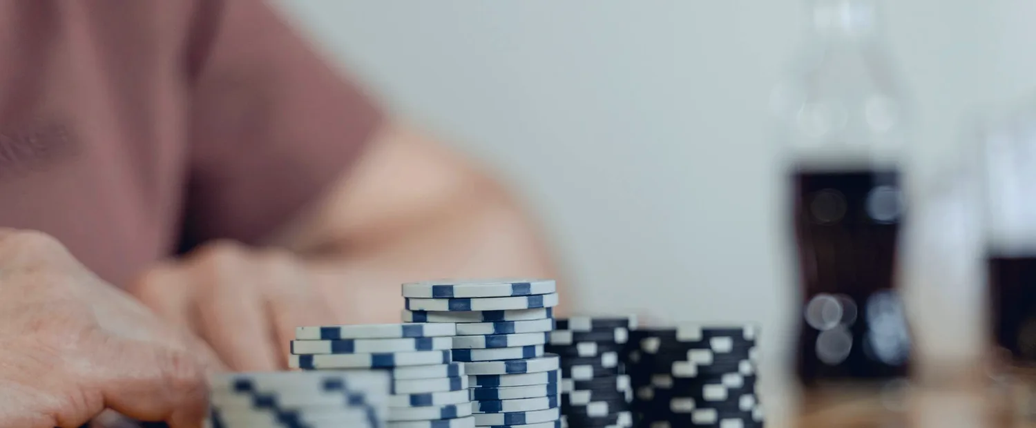 Blue-graded poker chips stacked on a table — the liquidity behind Betfair Poker's iPoker tables